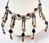 Front view of the Tibetan silver choker showing silver cones, lapis lazuli stones, floral bead connectors, and colorful bead tassels.