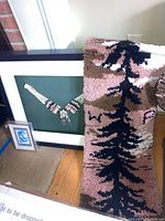 Overall display of wall art pieces and tree patterned tapestry, showing scale and colors.