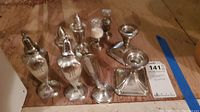 Photo showing the set containing two tall salt and pepper shakers, weighted sterling silver candle holders, and other pieces.