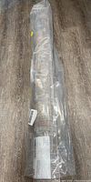 Rolled rug in protective plastic packaging, still new.