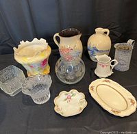 Full assortment view showing nine vintage items including pottery jugs, glassware, decorative dishes, and an oval platter.