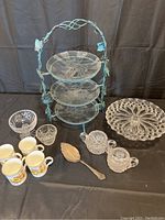 Full set with 3-tier glass serving stand, crystal cake stand, cream and sugar bowls, silver cake lifter, four floral tea mugs, two crystal bowls