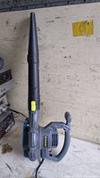 Side view of Yardworks electric leaf blower showing nozzle, handle, and power cord.