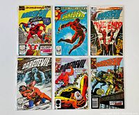 Six Daredevil comic books laid out flat showing full front covers.