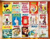 Flat lay of 17 MAD magazines showing colorful covers with satirical illustrations from the 1970s.