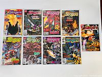 Lot of 9 Marvel Slingers comic books from 1998 displayed on white background. Includes various issues with vibrant covers and varying themes.