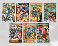 Set of seven Super Friends comic books from issues #33 to #39, showing front covers with various characters and scenes.