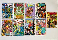 Ten X-Men comic books laid out flat with bright, illustrated covers showing various characters.