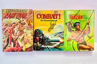 Front cover view of three pulp fiction novels: 'The Last Trail', 'Combat! The Counterattack', and 'Tarzan of the Apes' showing colorful illustrated dust jackets.