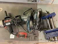 Photo of the Black & Decker Skilsaw, vintage Craftsman drill, and blue bench vise together on a work surface.