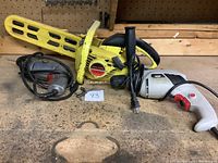 Yellow Skilsaw chain saw with protective blade cover and power cord coiled.