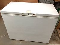 Front view of white chest freezer with closed lid