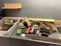 Wide view of entire collection including tracks, train cars, tunnel, green controller, and boxed items