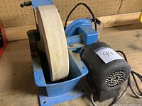 Wet wheel grinder showing the front side with motor and wheel stone.