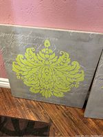 Canvas featuring yellow ornamental pattern on gray background with white script text