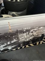 Image showing the full panoramic black and white picture with Eiffel Tower illuminated at night, framed in silver with a textured finish.
