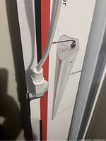 Close-up of the power cord plug attached to the light fixture box.