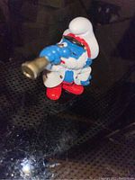 Front-angle photo showing the Captain Papa Smurf holding a telescope with detailed paint and colors.