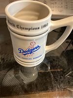 White ceramic mug with 1963 Dodgers World Champions logo and text visible.