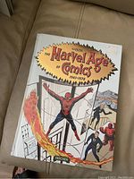 Photo of front cover of the sealed hardcover book titled 'The Marvel Age of Comics 1961-1978' by Taschen with Marvel superheroes on the cover.