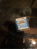 Photo of Nintendo DS game cartridge labeled Pokémon Mystery Dungeon: Explorers of Time with Nintendo DS logo at top and official rating marks.