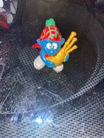 Front view of the Bagpipe Smurf figurine, showing the Smurf playing the yellow bagpipe with red and green tartan outfit.
