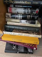 Photo showing spines of ten large history books stacked horizontally revealing titles and authors.