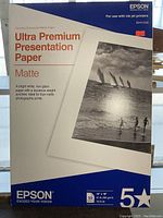 Front view of Epson Ultra Premium Presentation Paper Matte box with product details and photo example on front.