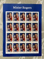 Full sheet showing 20 Mister Rogers Forever stamps on blue backing.