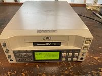 Front view of the JVC BR-DV600UA video cassette recorder showing control panel, display, and buttons.