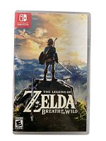 Front cover of the Nintendo Switch game case showing the artwork for The Legend of Zelda: Breath of the Wild with Link looking over the landscape.