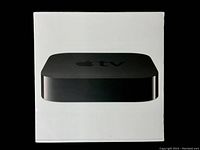 Front of the sealed white box showing the black Apple TV device on the front.