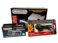 Front view of Nintendo Classic Mini Entertainment System box, NES Classic Mini controller box, and Nyko official 6 foot extension cable for NES Classic controller in original packaging.