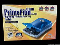 Front and top view of the PrimeFilm 1800i film scanner in its original retail packaging showing the device and key features.