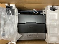 Printer unit in original packaging with foam inserts and protective wrap