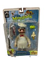 Front view of unopened packaging for The Muppets Classic Swedish Chef action figure with accessories inside plastic blister pack and colorful branded backing card.
