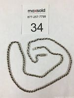 Full view of the 925 sterling silver rope chain necklace laid flat to display length and overall condition.