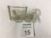 Clear glass donkey cart-shaped salt cellar from side angle showing detailed donkey with harness and two-wheeled rectangular open cart.