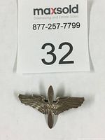 Front view of the sterling silver WW2 aviator wings pin with detailed feather design and propeller in the center.