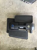 Top-down view of Cubii elliptical showing foot pedals, control knob, and display screen