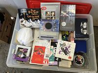 Full box view showing a variety of millennium-related memorabilia including books, DVDs, calendars, newspapers, and music CDs.