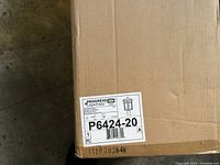 Photo of the unopened box of the porch light showing the label with brand Progress Lighting and model number P6424-20.
