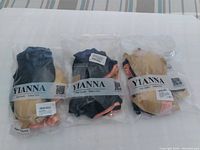 Three sealed plastic bags, each containing three YIANNA nursing bras in black, pink, and beige color combinations, size S.