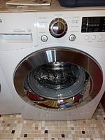 Front and top part of the LG washing machine showing door and controls
