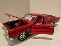 Front angle showing opened hood and driver door revealing engine details and interior.