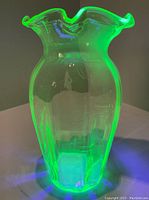 Vase under UV light showing bright green fluorescence