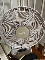 Close-up front view of Sunbeam portable fan showing protective grille and blades