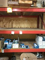 Empty shelf with boxes and small aquarium supply items on lower shelf