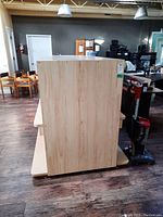 Side view showing smooth wood grain panel of the laminate display unit.