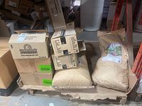 Pallet with cardboard boxes and two large kraft paper bags